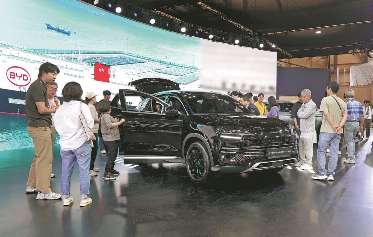 Visitors gather around a BYD electric vehicle at an expo in South Korea.