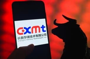 A smartphone shows the CXMT logo against a bull silhouette symbolizing a rising market.