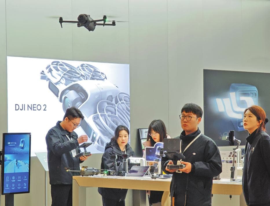 Visitors try out drones at a DJI store.