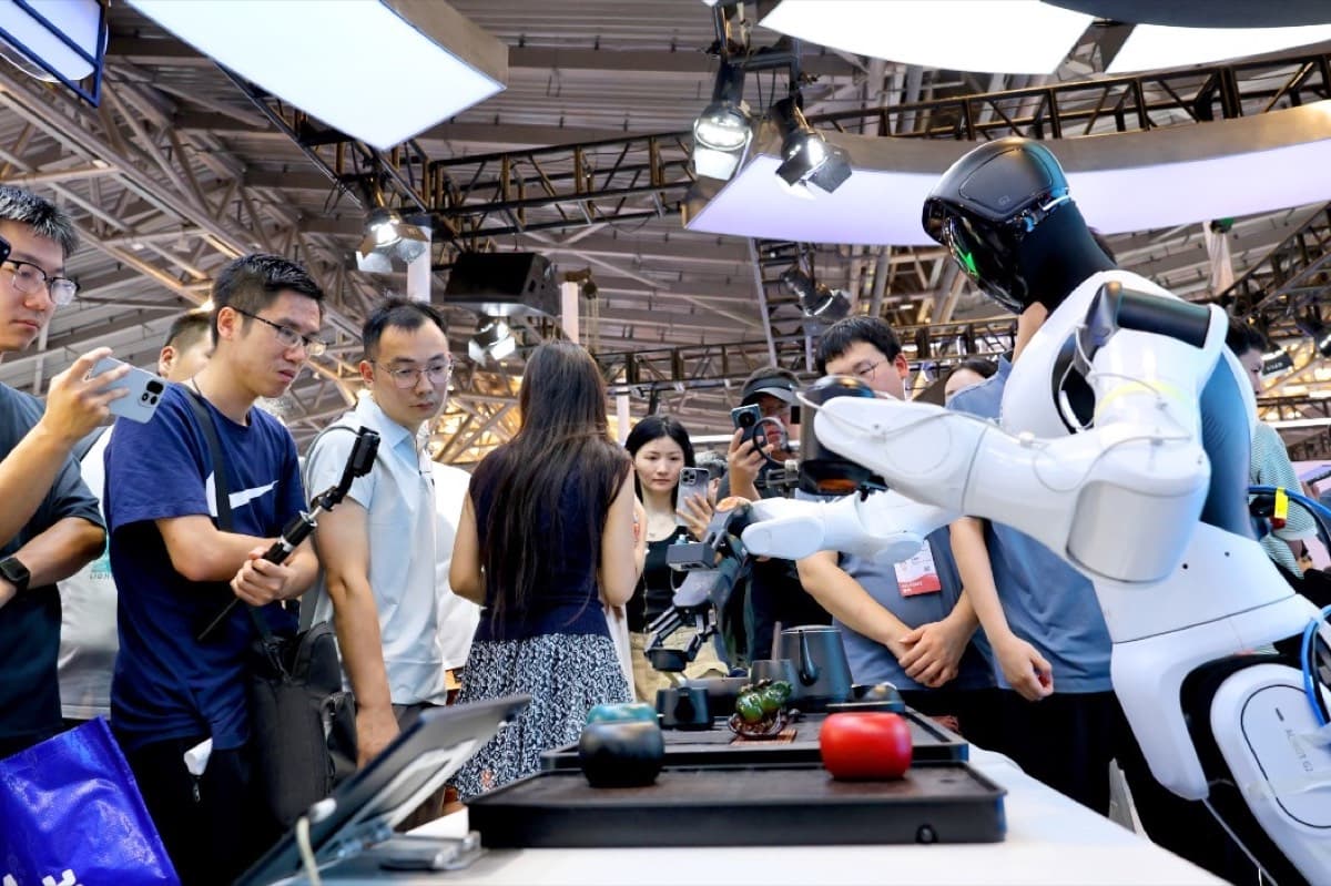 Visitors watch a humanoid robot demonstration at the World AI Conference in Shanghai.