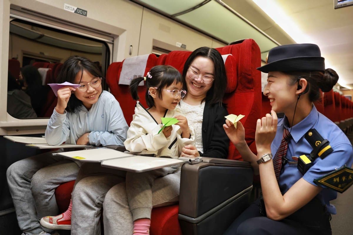 A high-speed train conductor makes origami with a family aboard.