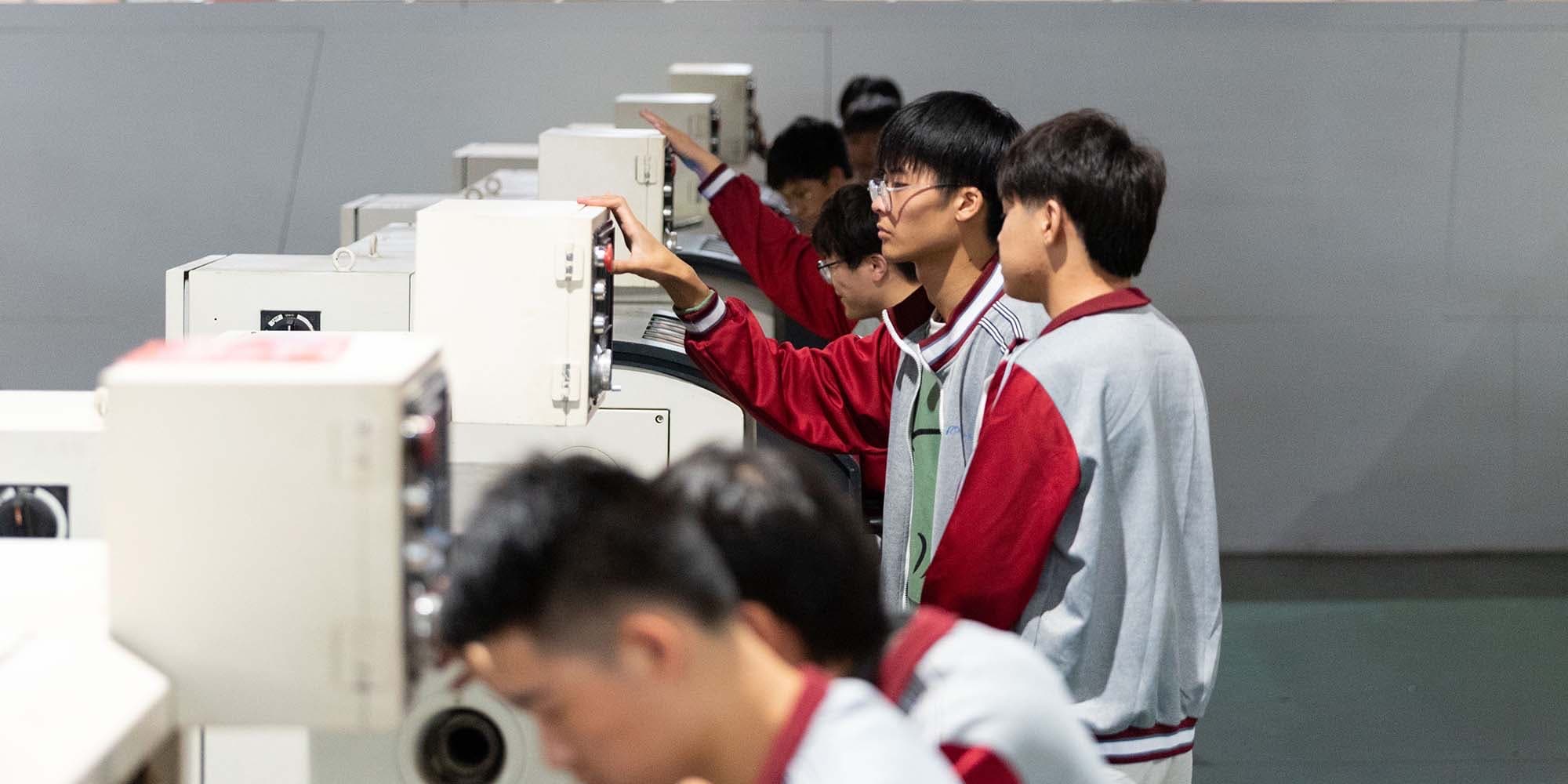 职业院校学生在实训车间操作设备